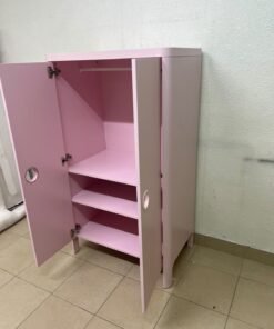 The "Busunge" children's wardrobe from IKEA comes in light pink and features rounded corners and distinctive circular cutouts that serve as handles. - Image 2