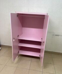 The "Busunge" children's wardrobe from IKEA comes in light pink and features rounded corners and distinctive circular cutouts that serve as handles. - Image 4