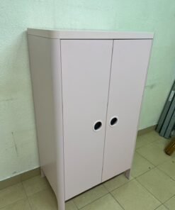 The "Busunge" children's wardrobe from IKEA comes in light pink and features rounded corners and distinctive circular cutouts that serve as handles. - Image 7
