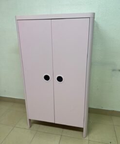 The "Busunge" children's wardrobe from IKEA comes in light pink and features rounded corners and distinctive circular cutouts that serve as handles. - Image 9