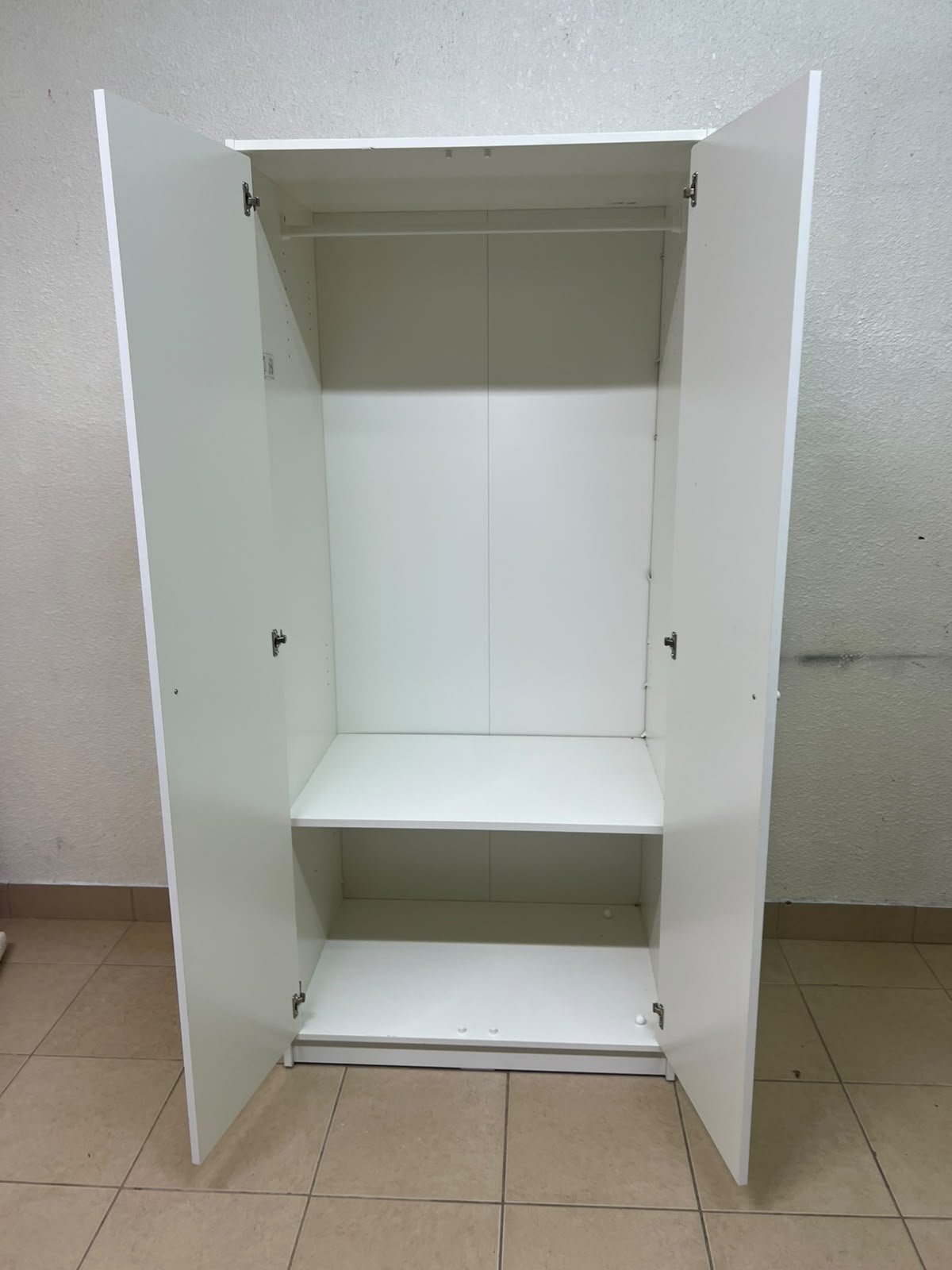 The IKEA KLEPPSTAD white two-door wardrobe features a simple design with two round handles and dimensions of 79x55x176 cm. - Image 9