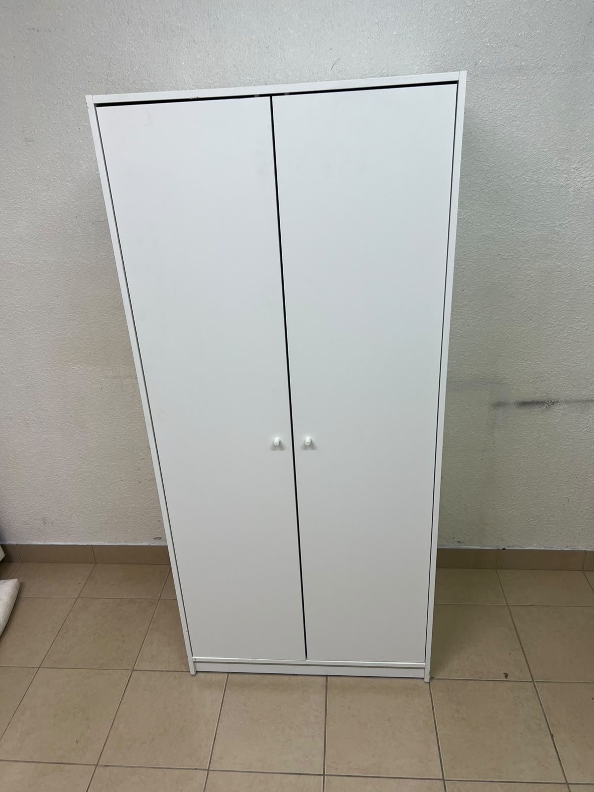 The IKEA KLEPPSTAD white two-door wardrobe features a simple design with two round handles and dimensions of 79x55x176 cm. - Image 3