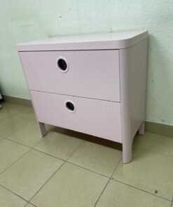 The "Busunge" chest of drawers from IKEA comes in light pink and features distinctive, circular cut-out handles. - Image 3