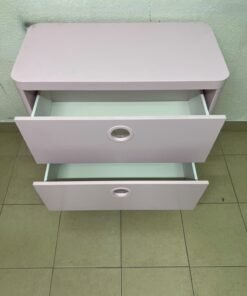 The "Busunge" chest of drawers from IKEA comes in light pink and features distinctive, circular cut-out handles. - Image 4