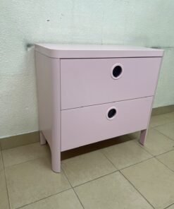 The "Busunge" chest of drawers from IKEA comes in light pink and features distinctive, circular cut-out handles. - Image 5