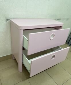 The "Busunge" chest of drawers from IKEA comes in light pink and features distinctive, circular cut-out handles. - Image 9