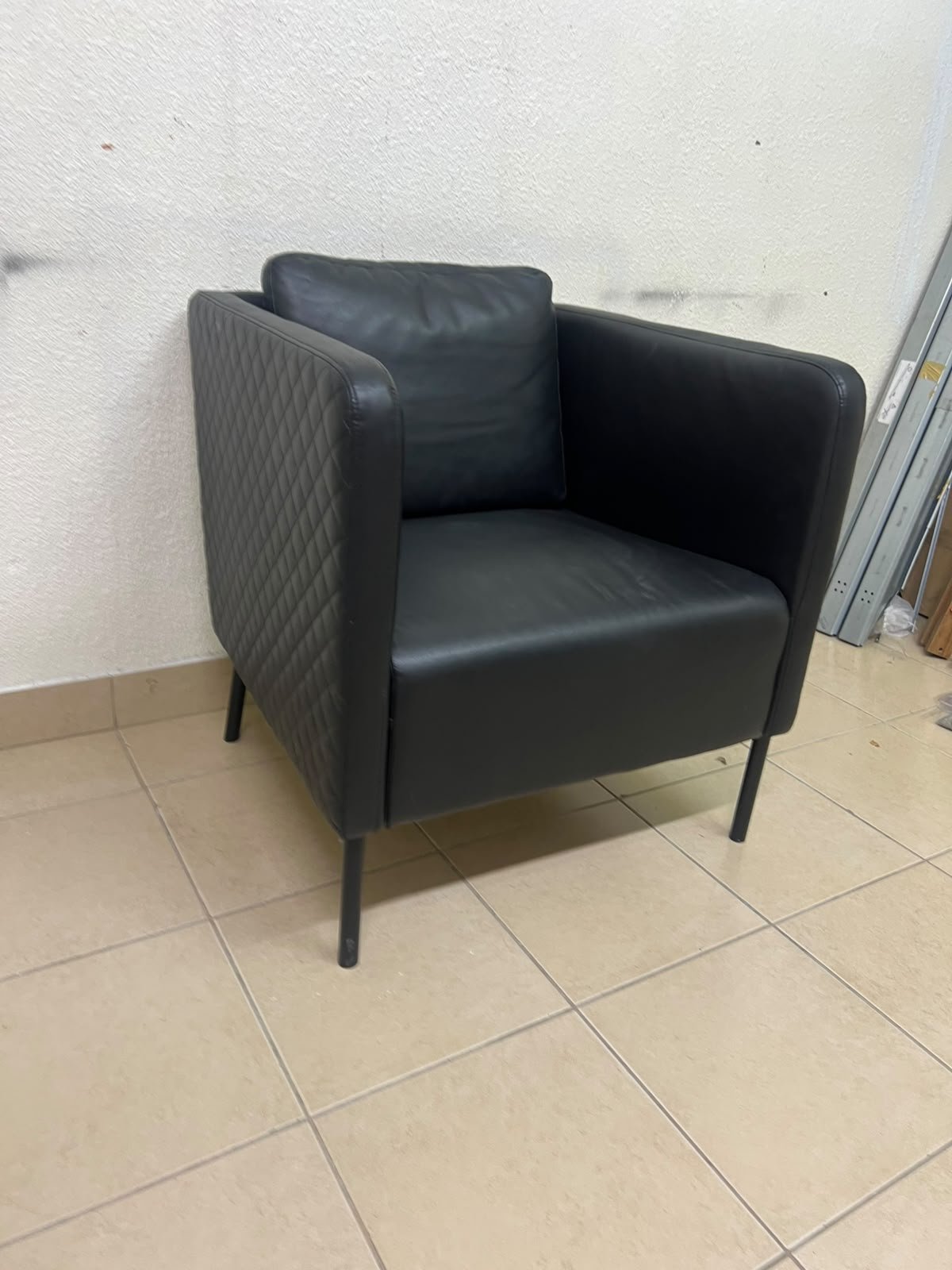 The IKEA EKERÖ armchair, upholstered in black Bomstad material, featuring distinctive slender black legs and a loose back cushion. - Image 2