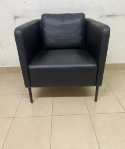 The IKEA EKERÖ armchair, upholstered in black Bomstad material, featuring distinctive slender black legs and a loose back cushion. - Image 3