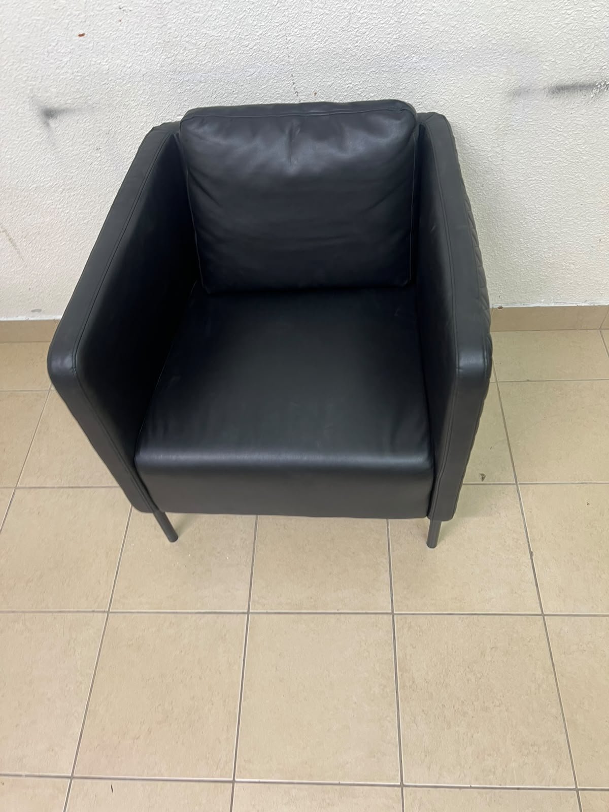 The IKEA EKERÖ armchair, upholstered in black Bomstad material, featuring distinctive slender black legs and a loose back cushion. - Image 6
