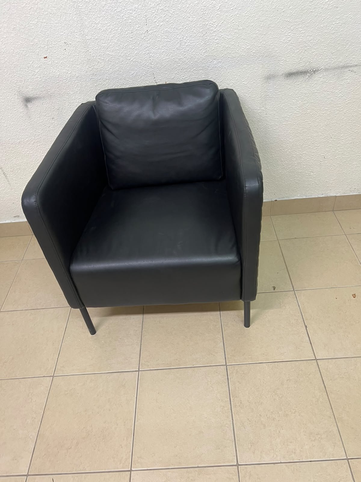 The IKEA EKERÖ armchair, upholstered in black Bomstad material, featuring distinctive slender black legs and a loose back cushion. - Image 9