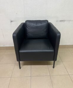 The IKEA EKERÖ armchair, upholstered in black Bomstad material, featuring distinctive slender black legs and a loose back cushion. - Image 10