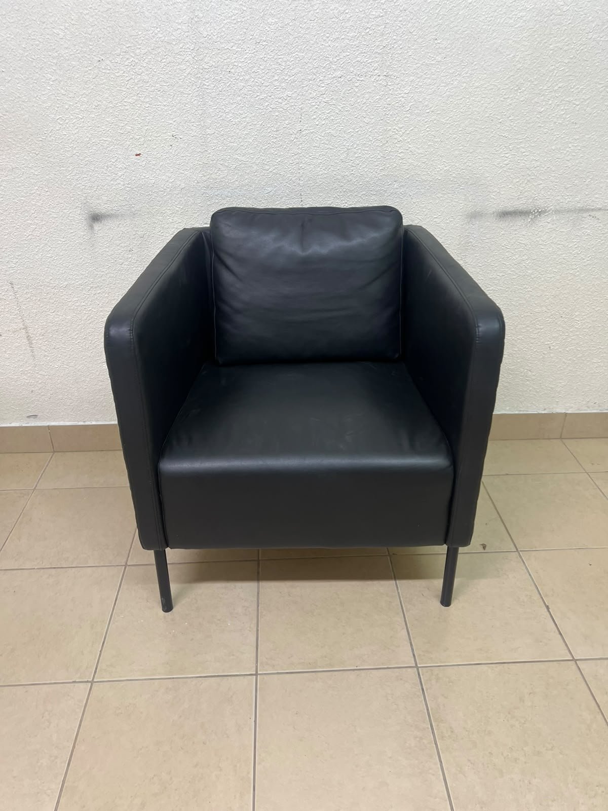 The IKEA EKERÖ armchair, upholstered in black Bomstad material, featuring distinctive slender black legs and a loose back cushion. - Image 10