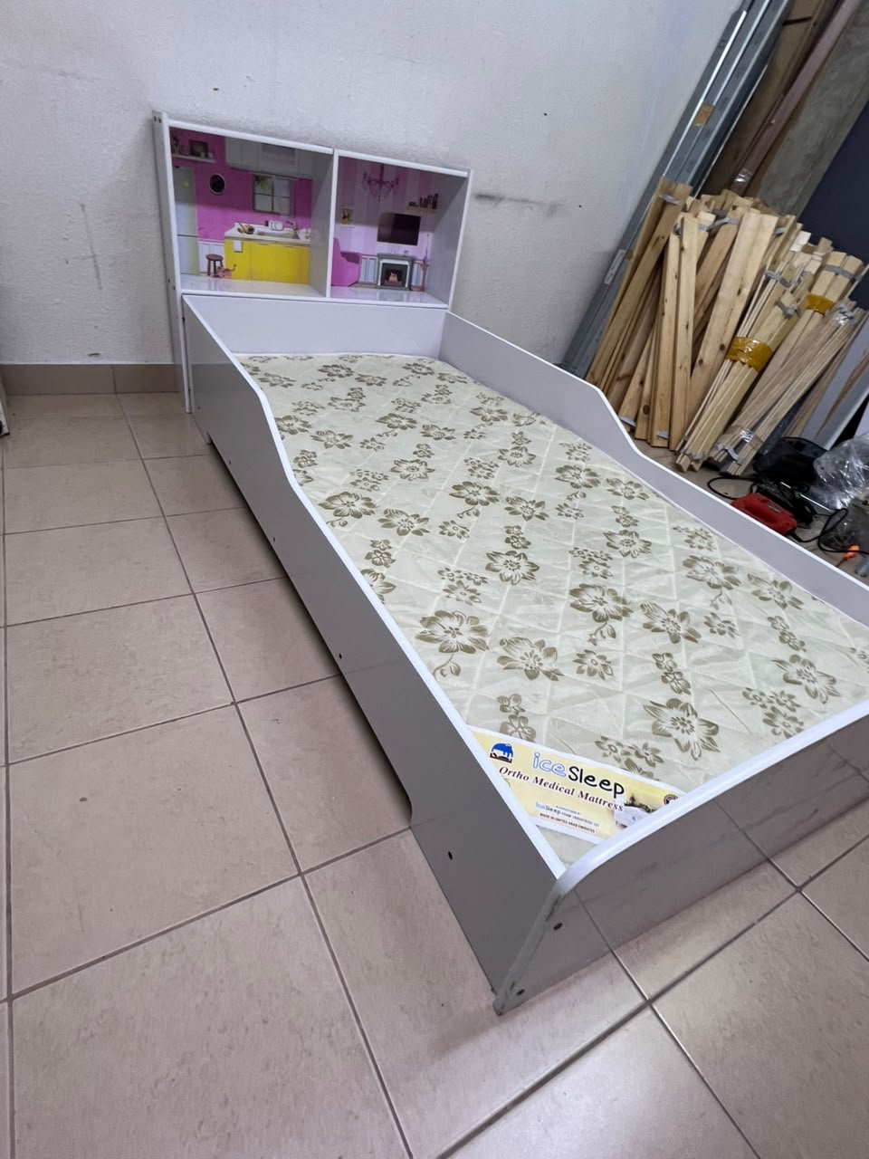 A white wooden single bed for children, featuring an integrated "dollhouse-style" headboard decorated with illustrations of miniature rooms. - Image 2
