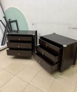 A pair of modern dark-wood bedside cabinets featuring three drawers, curved fronts, silver-colored handles, and elegant metal legs. - Image 2