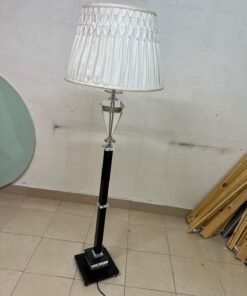 An elegant floor lamp combining crystal and black metal, featuring a conical, pleated fabric shade and a multi-faceted glass element positioned near the top of the lamp's stem. - Image 5