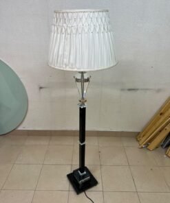 An elegant floor lamp combining crystal and black metal, featuring a conical, pleated fabric shade and a multi-faceted glass element positioned near the top of the lamp's stem. - Image 6