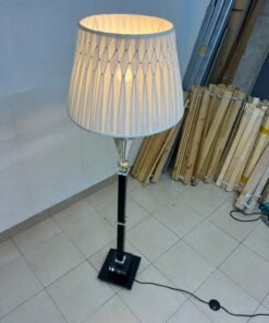 An elegant floor lamp combining crystal and black metal, featuring a conical, pleated fabric shade and a multi-faceted glass element positioned near the top of the lamp's stem. - Image 7
