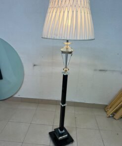 An elegant floor lamp combining crystal and black metal, featuring a conical, pleated fabric shade and a multi-faceted glass element positioned near the top of the lamp's stem. - Image 8