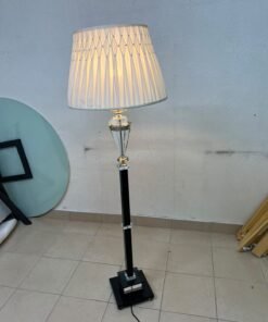An elegant floor lamp combining crystal and black metal, featuring a conical, pleated fabric shade and a multi-faceted glass element positioned near the top of the lamp's stem. - Image 9