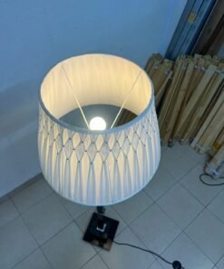 An elegant floor lamp combining crystal and black metal, featuring a conical, pleated fabric shade and a multi-faceted glass element positioned near the top of the lamp's stem. - Image 10
