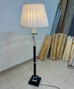 An elegant floor lamp combining crystal and black metal, featuring a conical, pleated fabric shade and a multi-faceted glass element positioned near the top of the lamp's stem. - Image 2