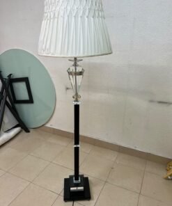 An elegant floor lamp combining crystal and black metal, featuring a conical, pleated fabric shade and a multi-faceted glass element positioned near the top of the lamp's stem. - Image 3