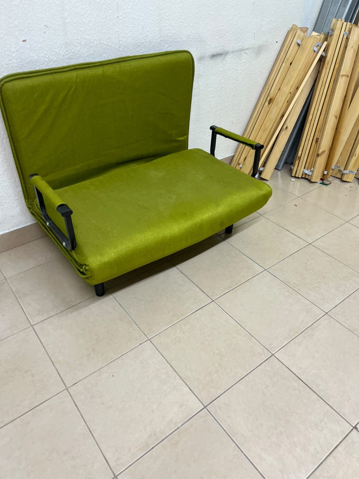 A multifunctional, foldable green sofa bed featuring black metal armrests and an adjustable backrest. - Image 5