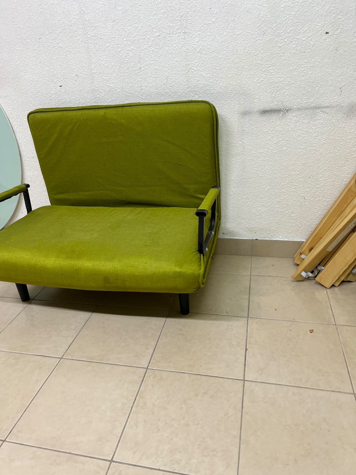 A multifunctional, foldable green sofa bed featuring black metal armrests and an adjustable backrest. - Image 6