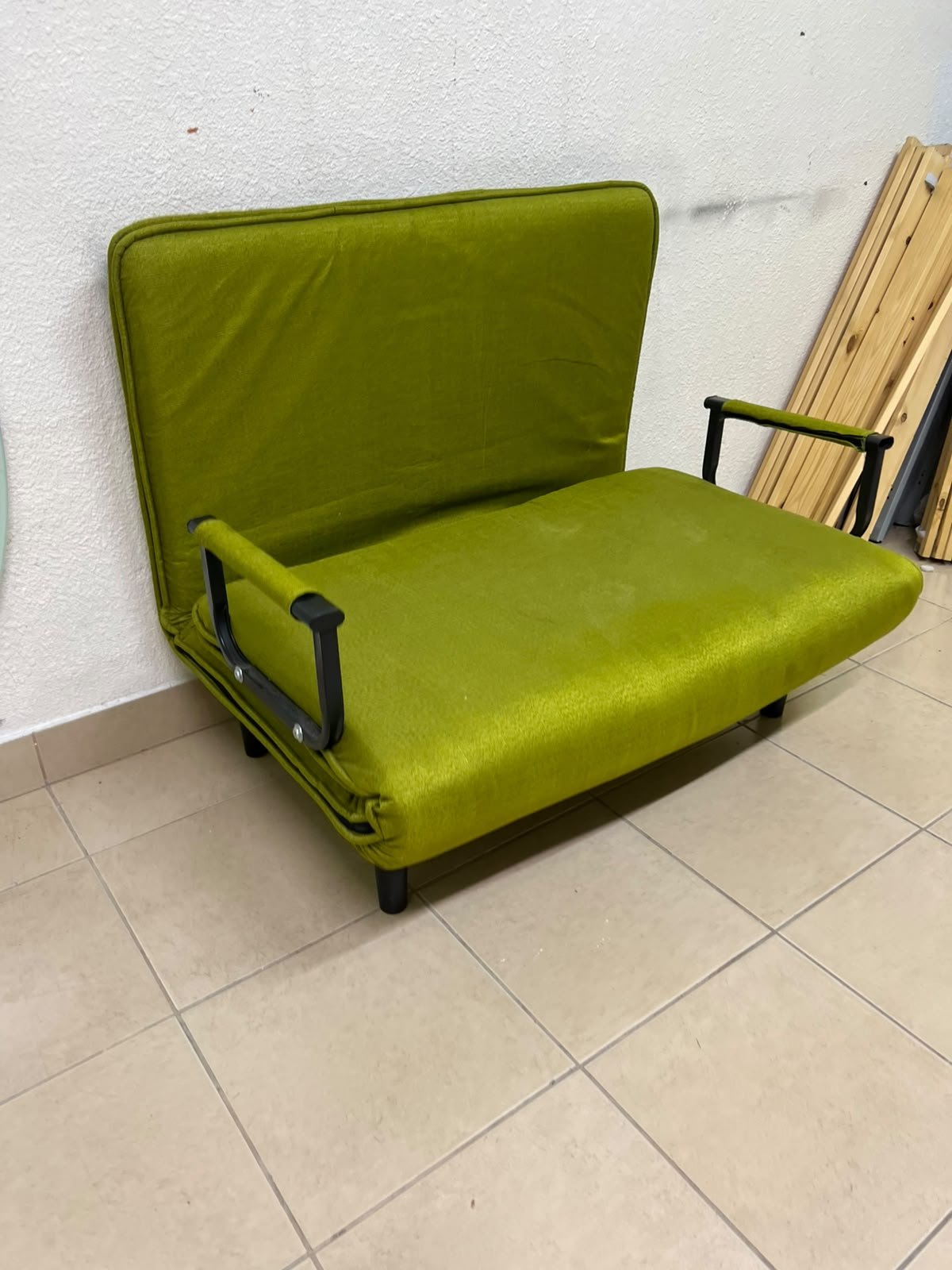 A multifunctional, foldable green sofa bed featuring black metal armrests and an adjustable backrest. - Image 7