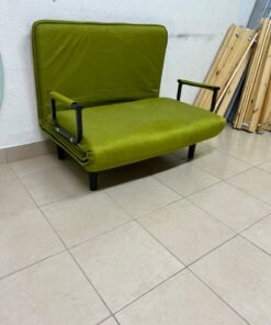 A multifunctional, foldable green sofa bed featuring black metal armrests and an adjustable backrest.