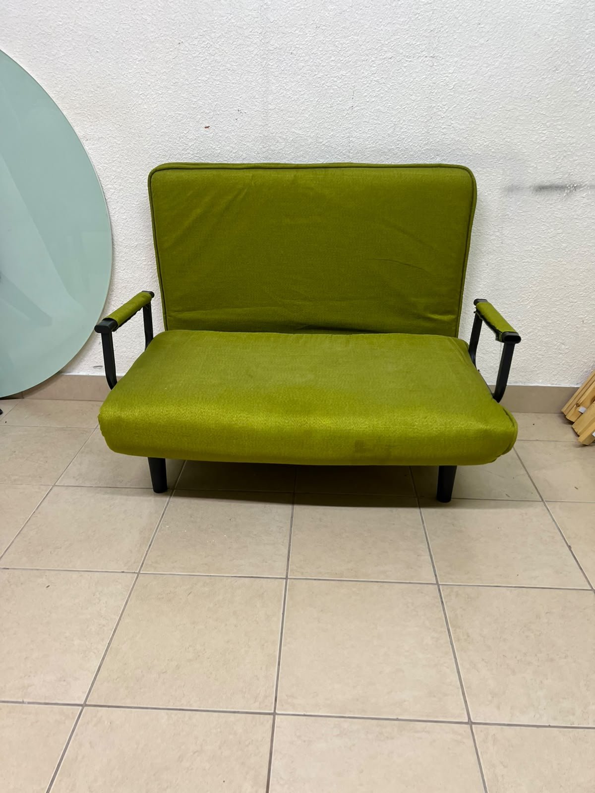 A multifunctional, foldable green sofa bed featuring black metal armrests and an adjustable backrest. - Image 9