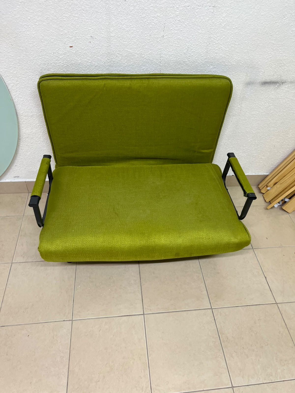 A multifunctional, foldable green sofa bed featuring black metal armrests and an adjustable backrest. - Image 4