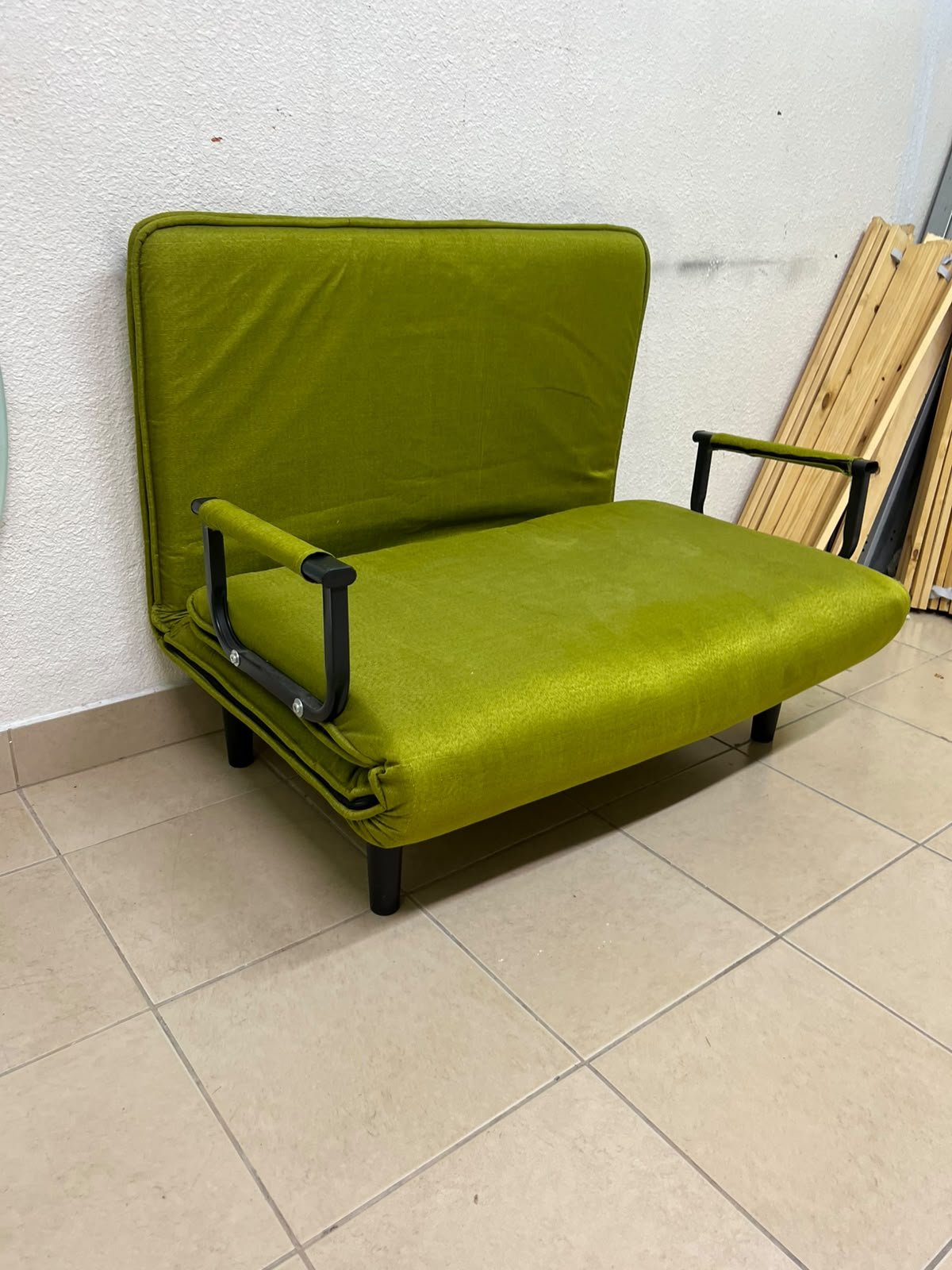 A multifunctional, foldable green sofa bed featuring black metal armrests and an adjustable backrest. - Image 3