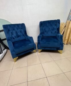 Wingback chairs upholstered in blue velvet, featuring ornate gold-finished metal legs. - Image 3