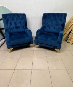 Wingback chairs upholstered in blue velvet, featuring ornate gold-finished metal legs. - Image 4