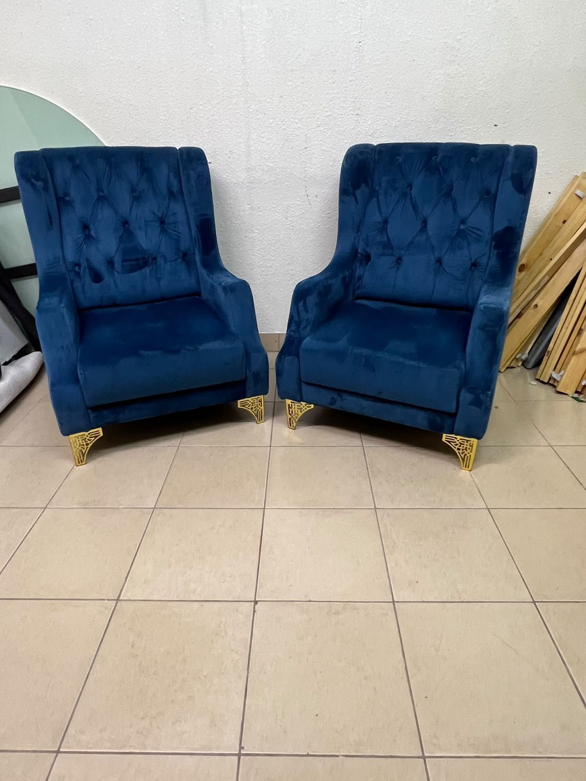 Wingback chairs upholstered in blue velvet, featuring ornate gold-finished metal legs. - Image 4