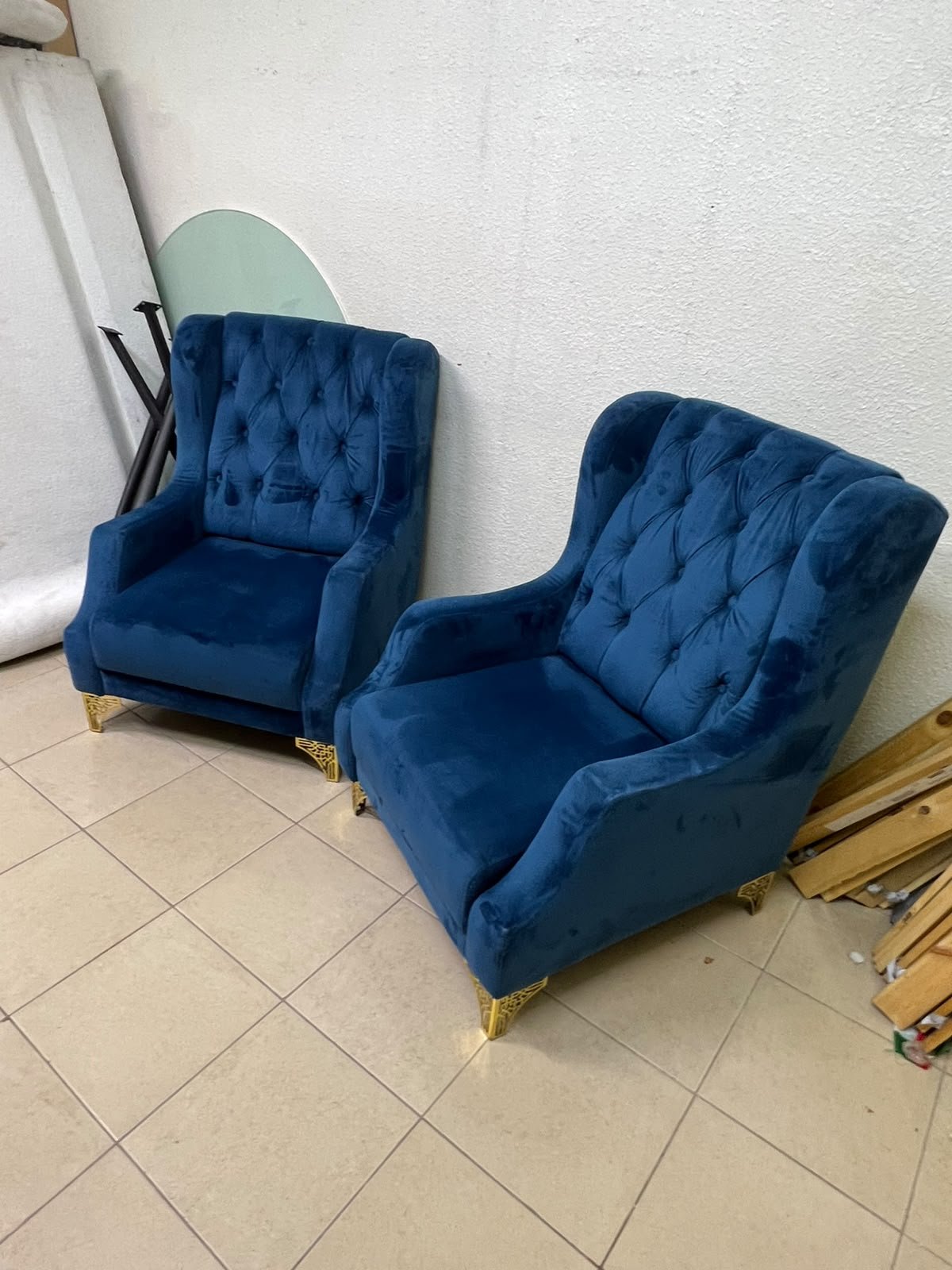 Wingback chairs upholstered in blue velvet, featuring ornate gold-finished metal legs. - Image 9