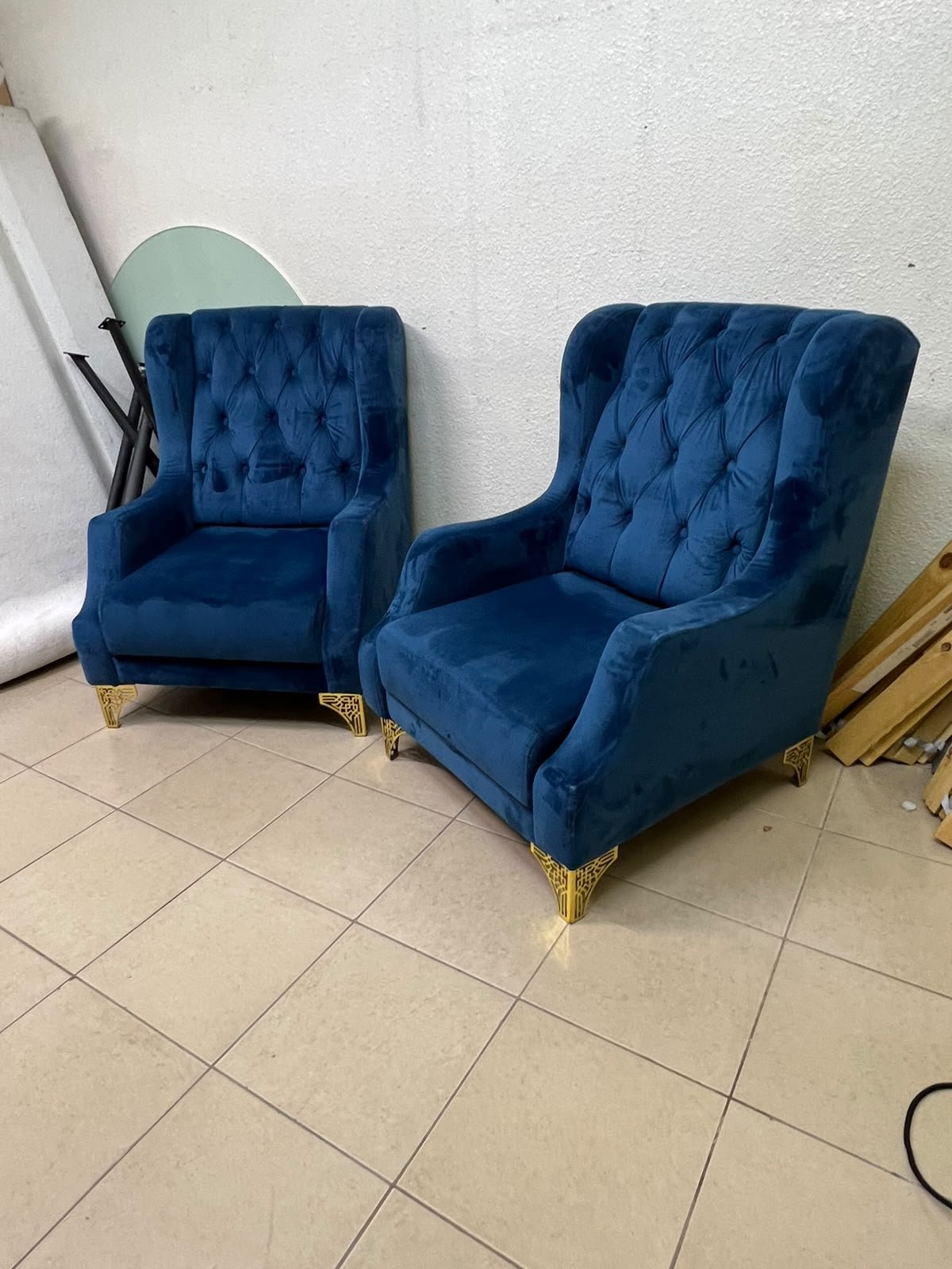 Wingback chairs upholstered in blue velvet, featuring ornate gold-finished metal legs. - Image 10