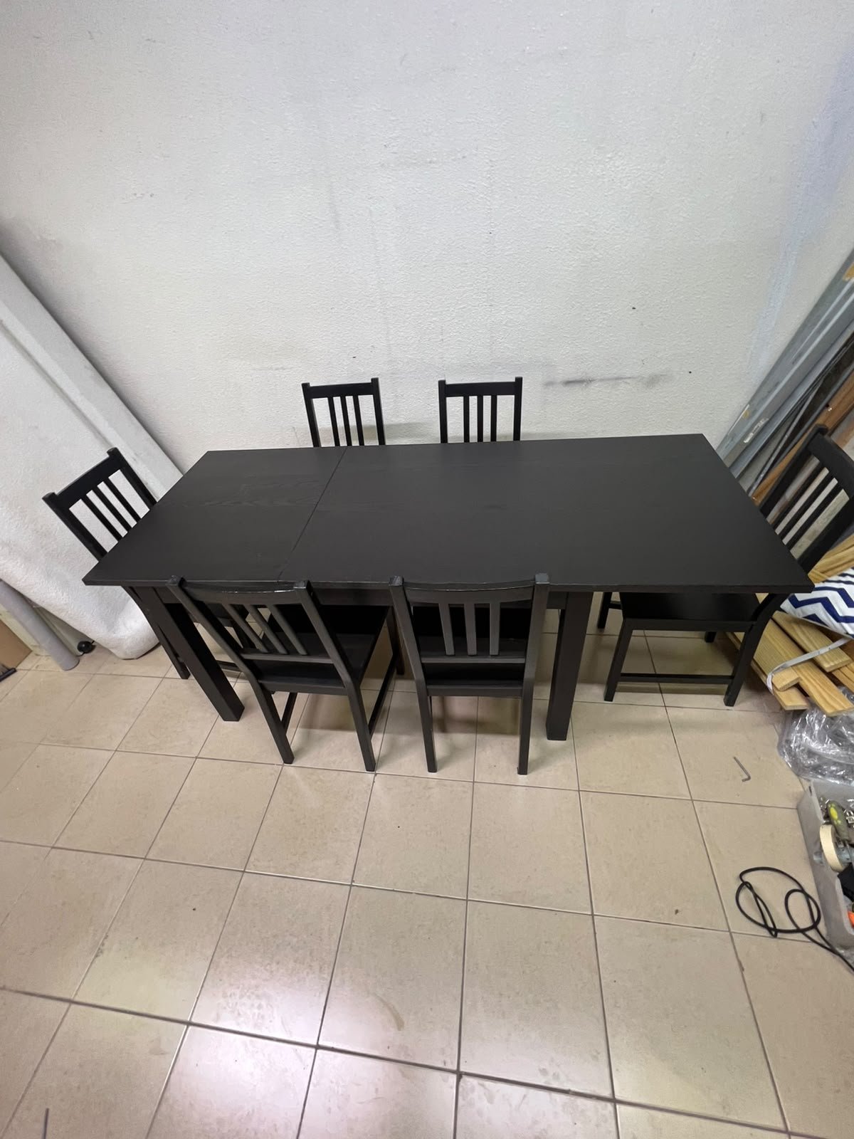A dark solid wood dining table with matching slat-back chairs, featuring the design of the "Nordviken" collection from IKEA. - Image 14