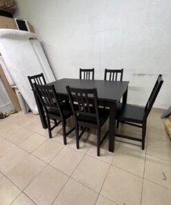 A dark solid wood dining table with matching slat-back chairs, featuring the design of the "Nordviken" collection from IKEA. - Image 10