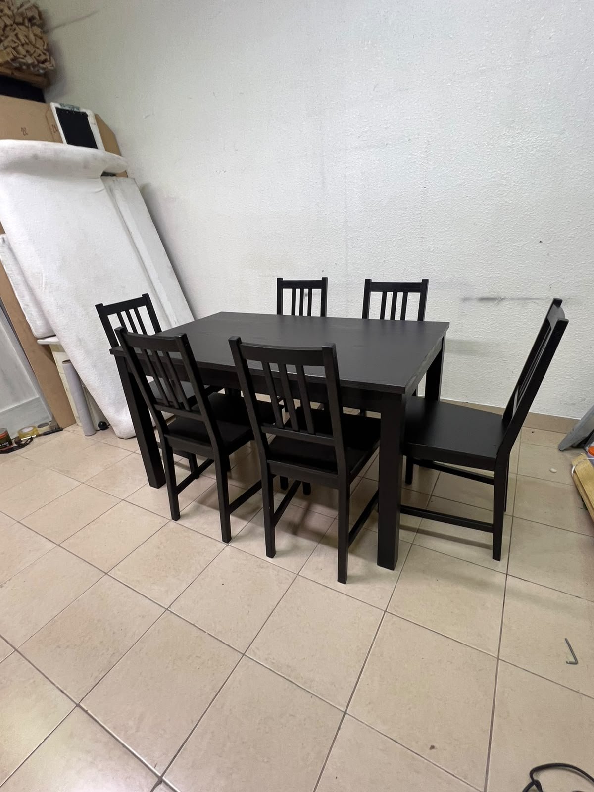 A dark solid wood dining table with matching slat-back chairs, featuring the design of the "Nordviken" collection from IKEA. - Image 10