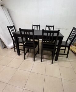 A dark solid wood dining table with matching slat-back chairs, featuring the design of the "Nordviken" collection from IKEA. - Image 11