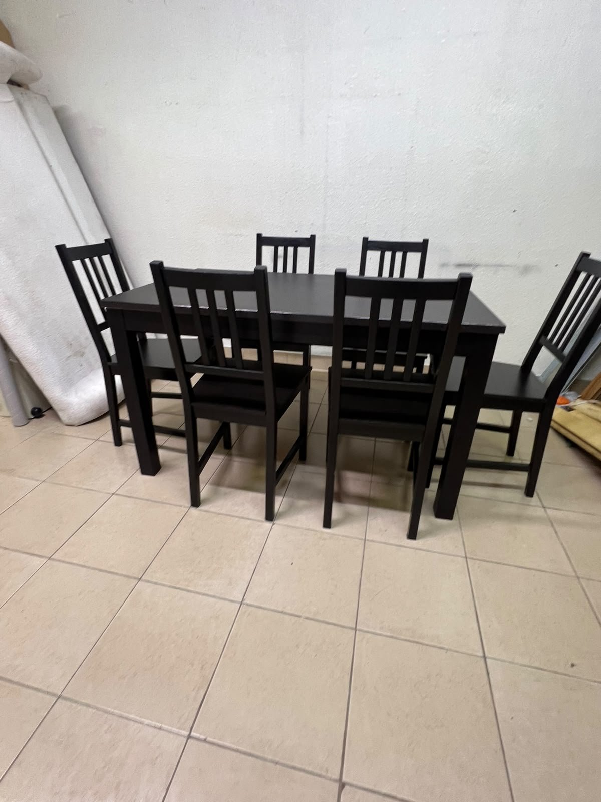 A dark solid wood dining table with matching slat-back chairs, featuring the design of the "Nordviken" collection from IKEA. - Image 11