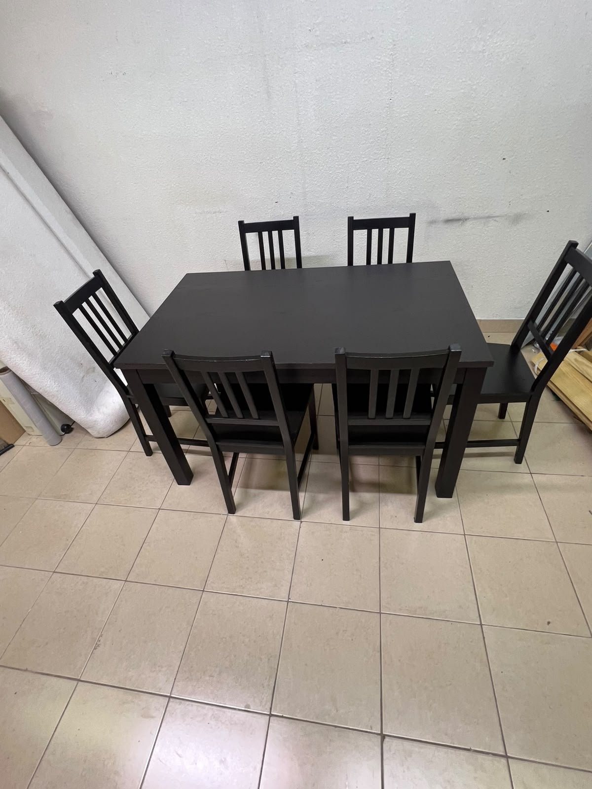 A dark solid wood dining table with matching slat-back chairs, featuring the design of the "Nordviken" collection from IKEA. - Image 12
