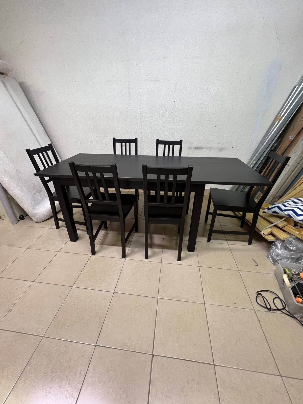 A dark solid wood dining table with matching slat-back chairs, featuring the design of the "Nordviken" collection from IKEA. - Image 13