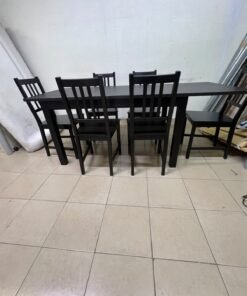 A dark solid wood dining table with matching slat-back chairs, featuring the design of the "Nordviken" collection from IKEA. - Image 3