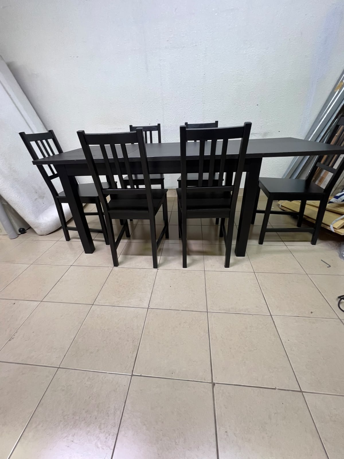A dark solid wood dining table with matching slat-back chairs, featuring the design of the "Nordviken" collection from IKEA. - Image 3