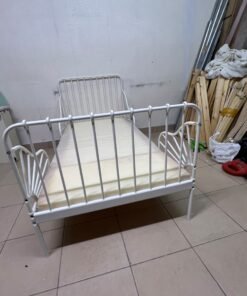 The white extendable metal bed frame "MINNEN" from IKEA, featuring side rails with distinctive scrollwork details. - Image 2