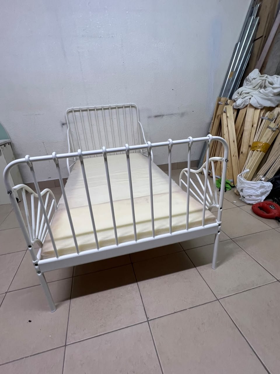 The white extendable metal bed frame "MINNEN" from IKEA, featuring side rails with distinctive scrollwork details. - Image 2
