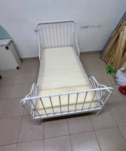 The white extendable metal bed frame "MINNEN" from IKEA, featuring side rails with distinctive scrollwork details. - Image 4